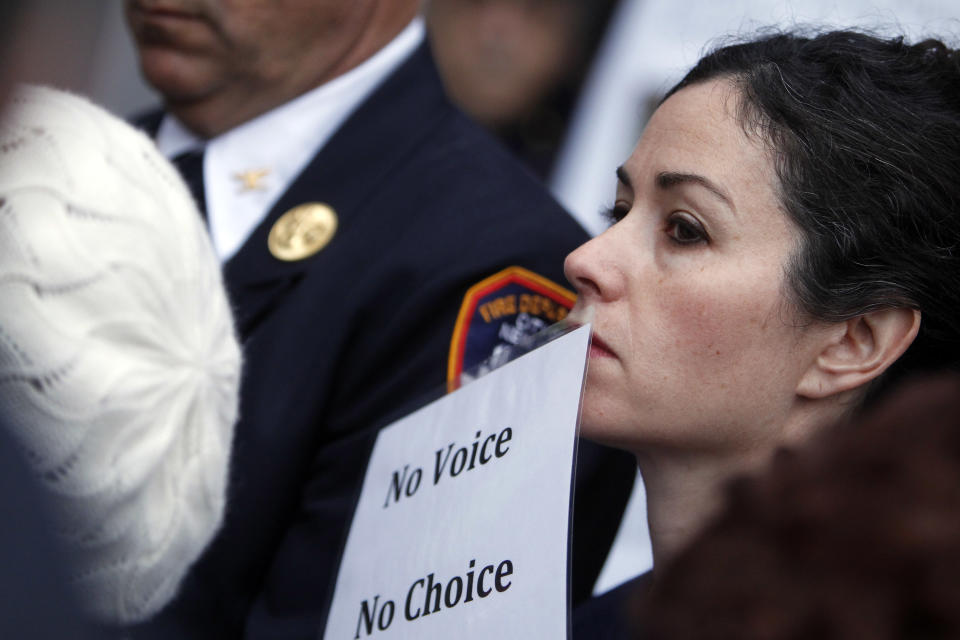 Rosaleen Tallon, whose son Sean was killed in Sept. 11, 2001 attacks, joins other family members of 9/11 victims to protest of the transfer of unidentified remains of those killed at the World Trade Center from the Office of the Chief Medical Examiner to the World Trade Center site, Saturday, May 10, 2014, in New York. The remains will be transferred to an underground repository in the same building as the National September 11 Memorial Museum. (AP Photo/Jason DeCrow)