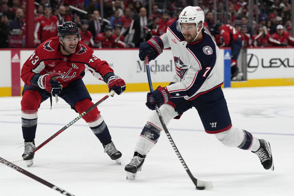 Columbus Blue Jackets center Sean Kuraly (7) takes a shot in front of Washington Capitals right wing Tom Wilson (43) during the second period of an NHL hockey game in Washington, Saturday, Nov. 18, 2023. (AP Photo/Susan Walsh)