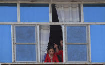 <p>Afghan girls look at the site of a suicide attack through a window of their building in Kabul on Aug. 29, 2017. (Photo: Shah Marai/AFP/Getty Images) </p>