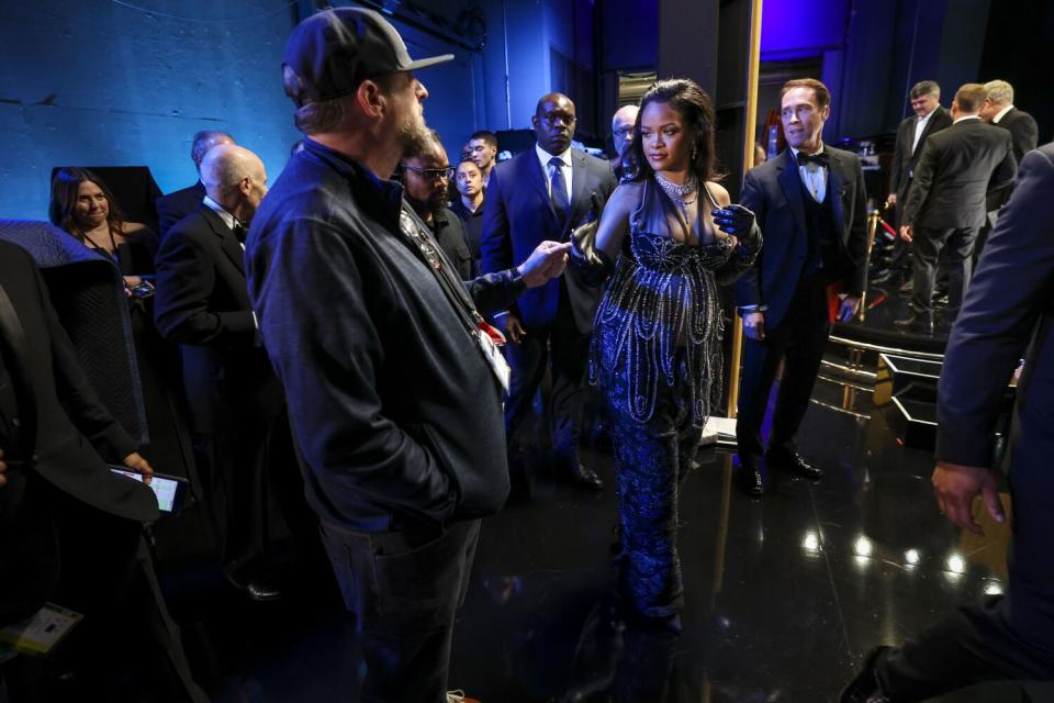 A woman is the center of attention backstage at the Oscars.