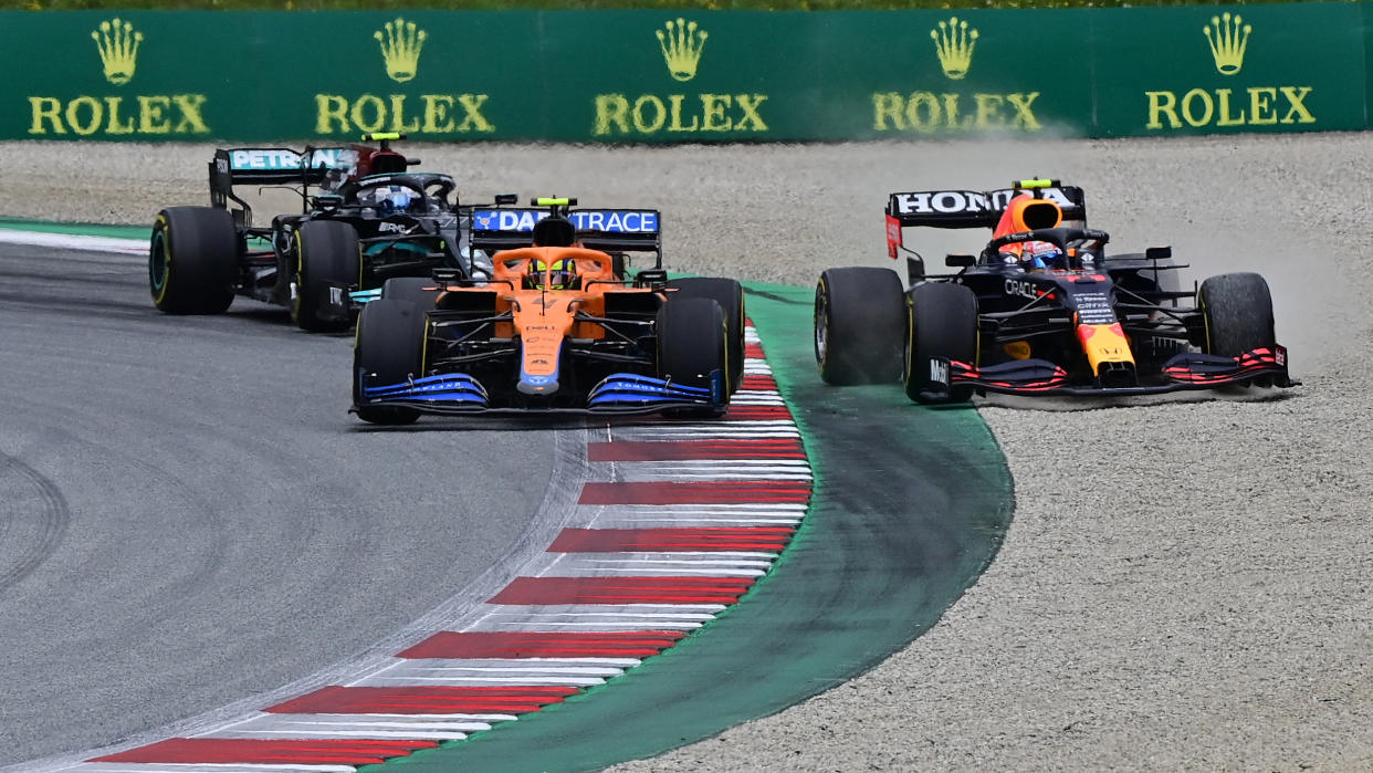 Red Bull's Mexican driver Sergio Perez (R) drives off the track as he competes with McLaren's British driver Lando Norris (C) and Mercedes' Finnish driver Valtteri Bottas during the Formula One Austrian Grand Prix at the Red Bull Ring race track in Spielberg, Austria, on July 4, 2021. (Photo by ANDREJ ISAKOVIC / AFP) (Photo by ANDREJ ISAKOVIC/AFP via Getty Images)