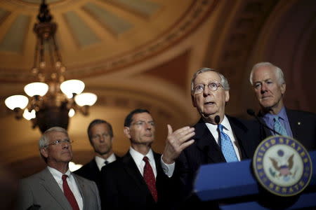 Senate Majority Leader Senator Mitch McConnell (R-KY) (C) speaks during a news conference accompanied by (L-R) Senator Roger Wicker (R-MS), Senator John Thune (R-SD), Senator John Barrasso (R-WY) and Senator John Cornyn (R-TX), following party policy lunch meeting at the U.S. Capitol in Washington August 4, 2015. REUTERS/Carlos Barria