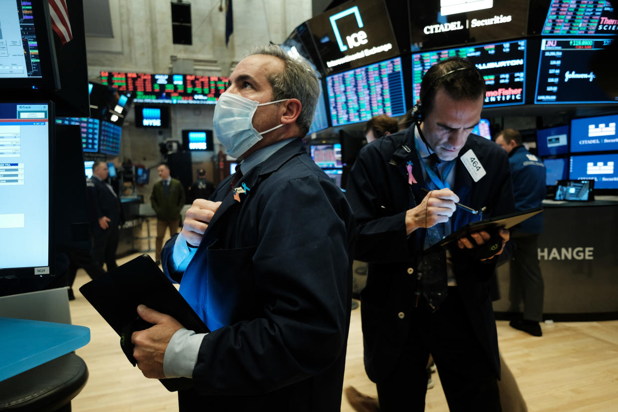 NEW YORK, NEW YORK - MARCH 20: Traders, some in medical masks, work on the floor of the New York Stock Exchange (NYSE) on March 20, 2020 in New York City. Trading on the floor will temporarily become fully electronic starting on Monday to protect employees from spreading the coronavirus. The Dow fell over 500 points on Friday as investors continue to show concerns over COVID-19.  (Photo by Spencer Platt/Getty Images)