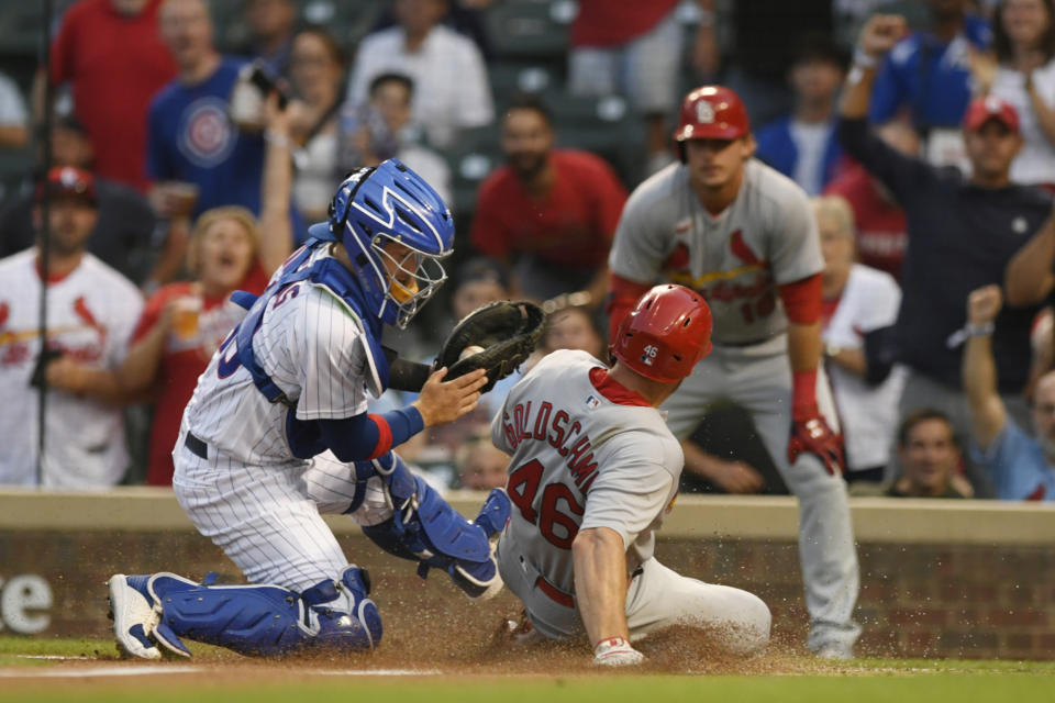 Chicago Cubs catcher P.J. Higgins, left, tags out St. Louis Cardinals' Paul Goldschmidt (46) at home plate during the first inning of the second game of a baseball doubleheader Tuesday, Aug. 23, 2022, in Chicago. (AP Photo/Paul Beaty)