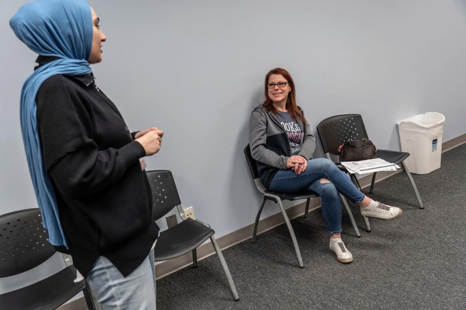 Natisha Holder, right, of Romulus, listens to site coordinator Batoul Fardous about the status of her tax filing at the Accounting Aid Society Northwest Financial Hub in Detroit on March 16, 2023. Households with income below $60,000 can qualify for free tax preparation unless they include things such as including rental income; business use of the home, or someone who is self-employed with inventory or costs of goods sold.
