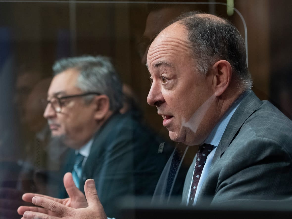 Quebec Health Minister Christian Dubé, right, says he is counting on Quebecers to be responsible and use their judgment as restrictions on indoor gatherings are further relaxed for the holidays. Public Health Director Dr. Horacio Arruda, left, advised vaccinated people not to gather indoors with unvaccinated people.  (The Canadian Press/Jacques Boissinot - image credit)