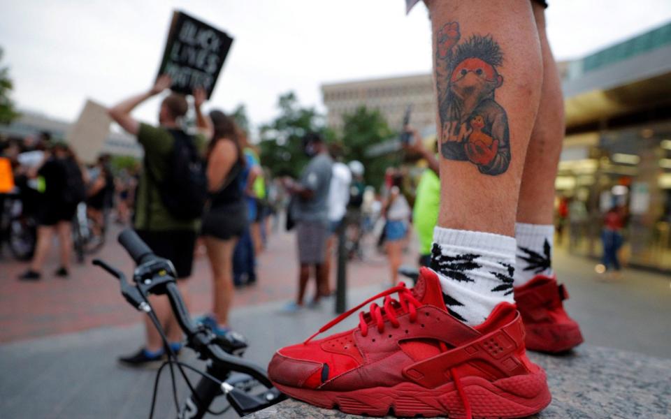 A man with a Black Lives Matter tattoo at a march in Boston in the US. UK Parliamentary staff have been urged to “pledge their support” for BAME colleagues following the death of George Floyd in May in the US - Brian Snyder/Reuters