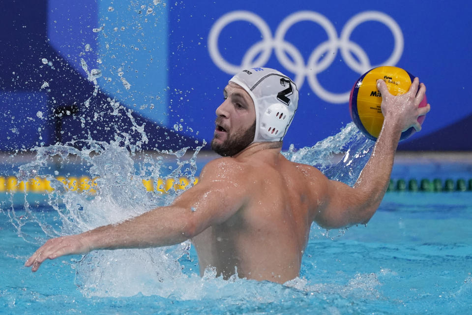 Greece's Konstantinos Genidounias plays against Japan during a preliminary round men's water polo match at the 2020 Summer Olympics, Thursday, July 29, 2021, in Tokyo, Japan. (AP Photo/Mark Humphrey)