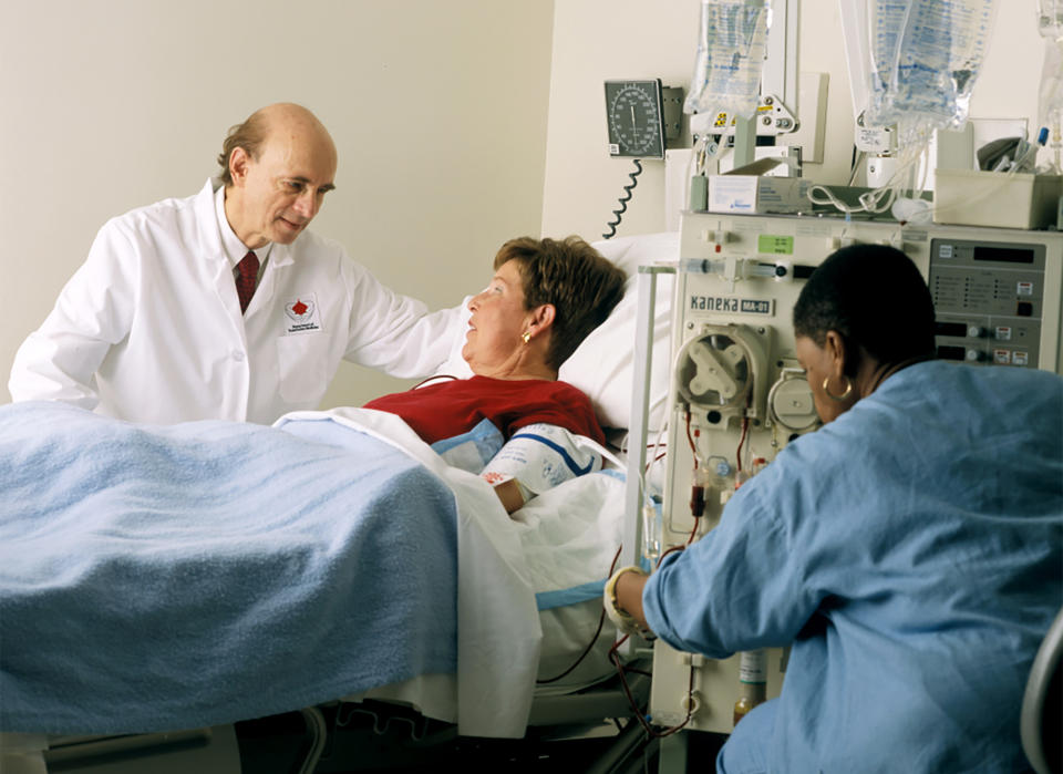 In this undated photo provided by the National Institutes of Health, Harvey J. Alter, left, talks to a patient hooked up to a Kaneka-fuchi Co. Liposorber MA-01, at the National Institutes of Health in Bethesda, Md. Alter and fellow American Charles M. Rice and British-born scientist Michael Houghton jointly won the Nobel Prize for medicine on Monday, Oct. 5, 2020, for their discovery of the hepatitis C virus, a major source of liver disease that affects millions worldwide. (Rhoda Baer/Office of National Institutes of Health History and Stetten Museum via AP)