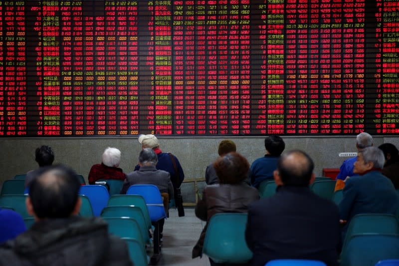 Investors look at an electronic board showing stock information at a brokerage house in Shanghai, China, January 3, 2017. REUTERS/Aly Song