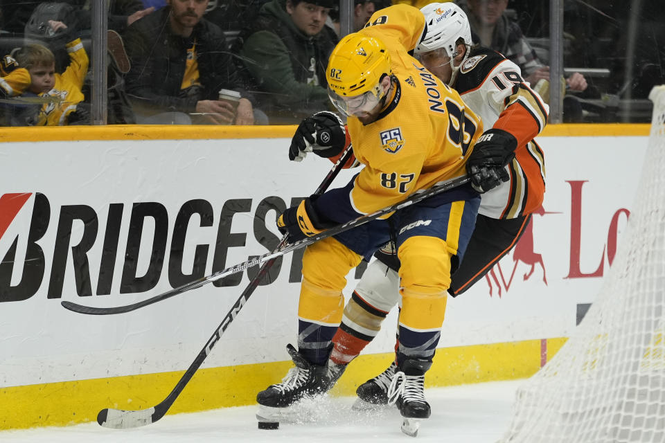 Nashville Predators center Tommy Novak (82) and Anaheim Ducks right wing Troy Terry (19) battle for the puck during the second period of an NHL hockey game Tuesday, Jan. 9, 2024, in Nashville, Tenn. (AP Photo/George Walker IV)