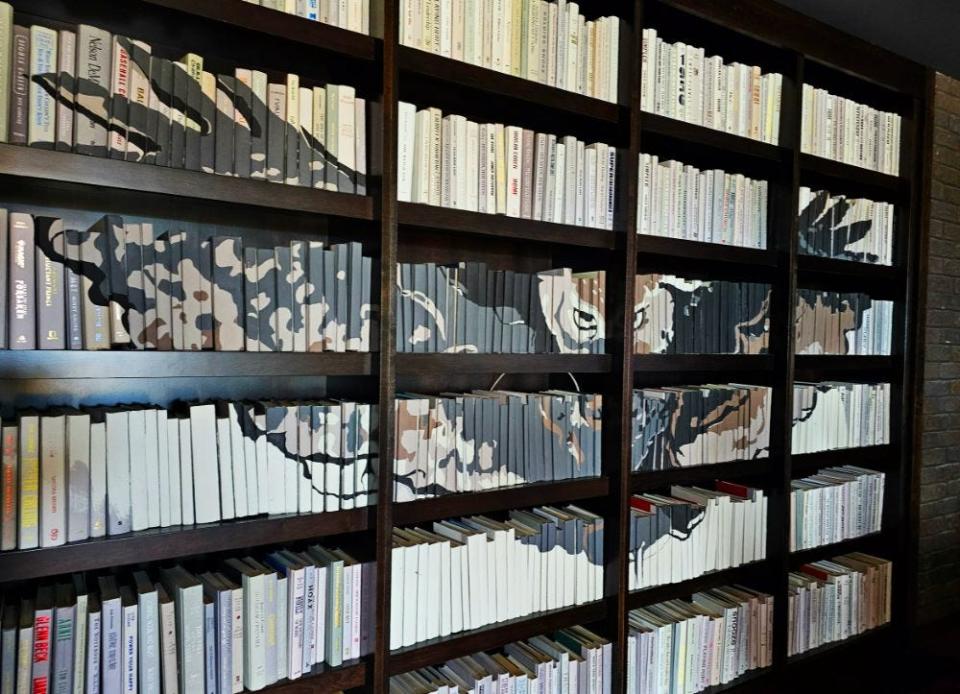 The second-floor hostess stand features seating as well as a bookshelf with spines that make an owl at Ruth's Chris Steak House in West Des Moines.