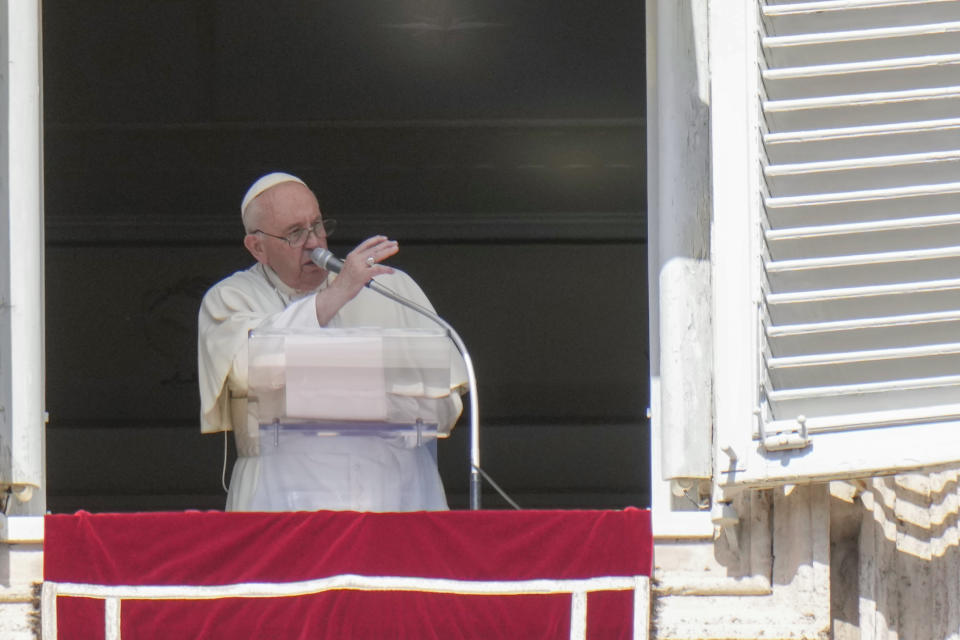 Pope Francis blesses faithful at the end of the Angelus noon prayer from the window of his studio overlooking St.Peter's Square, at the Vatican, Sunday, Oct. 2, 2022. Pope Francis has appealed to Russian President Vladimir Putin, imploring him to "stop this spiral of violence and death" in Ukraine. The pontiff also called on Ukrainian President Volodymyr Zelenskyy to "be open" to serious peace proposals. (AP Photo/Alessandra Tarantino)