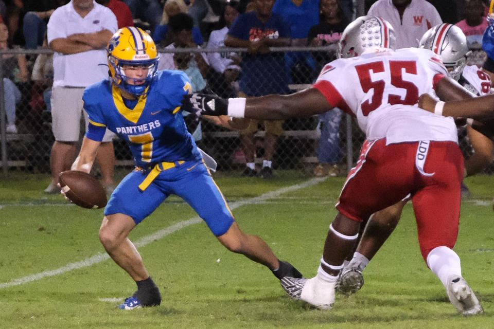 Williston Red Devils defensive tackle Ira Warren Jr. (55) rushes Newberry Panthers Keil Mcgriff (7) during a game at Newberry High School in Newberry Fl. on Friday, Oct. 6, 2023. [Chris Watkins]