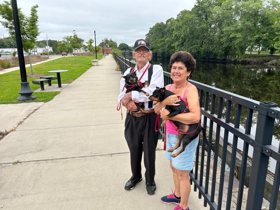 Taunton resident Alonso Miguel and his wife Luzia enjoy a walk along the Taunton River with their dogs on Monday, Aug. 28, 2023.