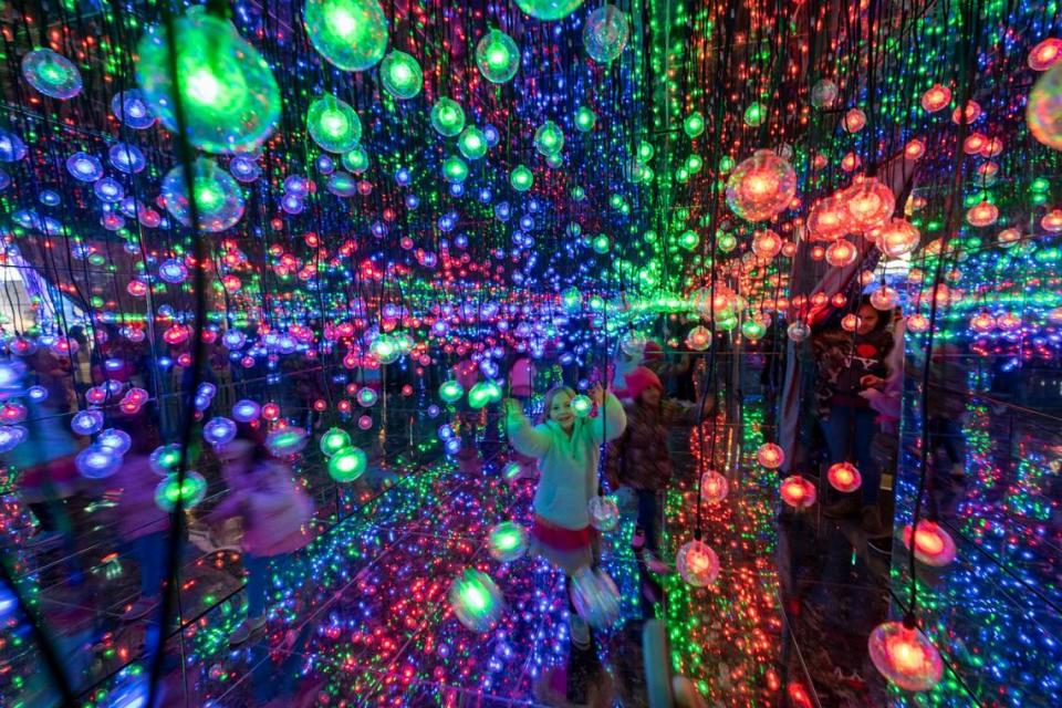 Visitors walk among the illuminated displays at the NC Chinese Lantern Festival on Tuesday, Nov. 14, 2023 at Koka Booth Amphitheatre in Cary. The festival, in its eighth year, features 40 new displays with thousands of LED lights. The event runs from Nov. 17 through Jan. 14.