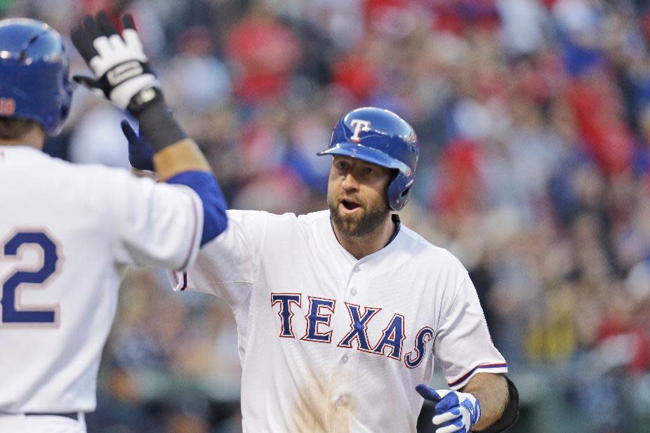 Texas Rangers Kevin Kouzmanoff celebrates his solo home run during the second inning of the MLB American League baseball game against the Seattle Mariners Tuesday, April 15, 2014, in Arlington, Texas. (AP Photo/LM Otero)