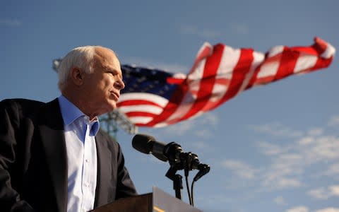 Arizona Sen. John McCain speaks at a campaign rally at Raymond James Stadium in 2008  - Credit:  ROBYN BECK/AFP