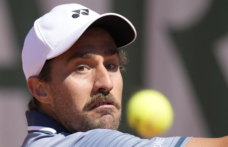 United States's Steve Johnson eyes the ball as he plays a return to United States's Frances Tiafoe during their first round match on day two of the French Open tennis tournament at Roland Garros in Paris, France, Monday, May 31, 2021. (AP Photo/Christophe Ena)