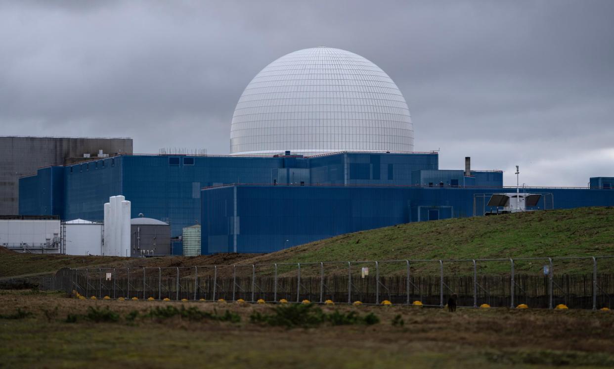 <span>Sizewell B nuclear power station stands behind a fence marking the site of the under-construction Sizewell C. The government is planning another nuclear power station for either Wylfa on Anglesey or Moorside in Cumbria. </span><span>Photograph: Carl Court/Getty Images</span>