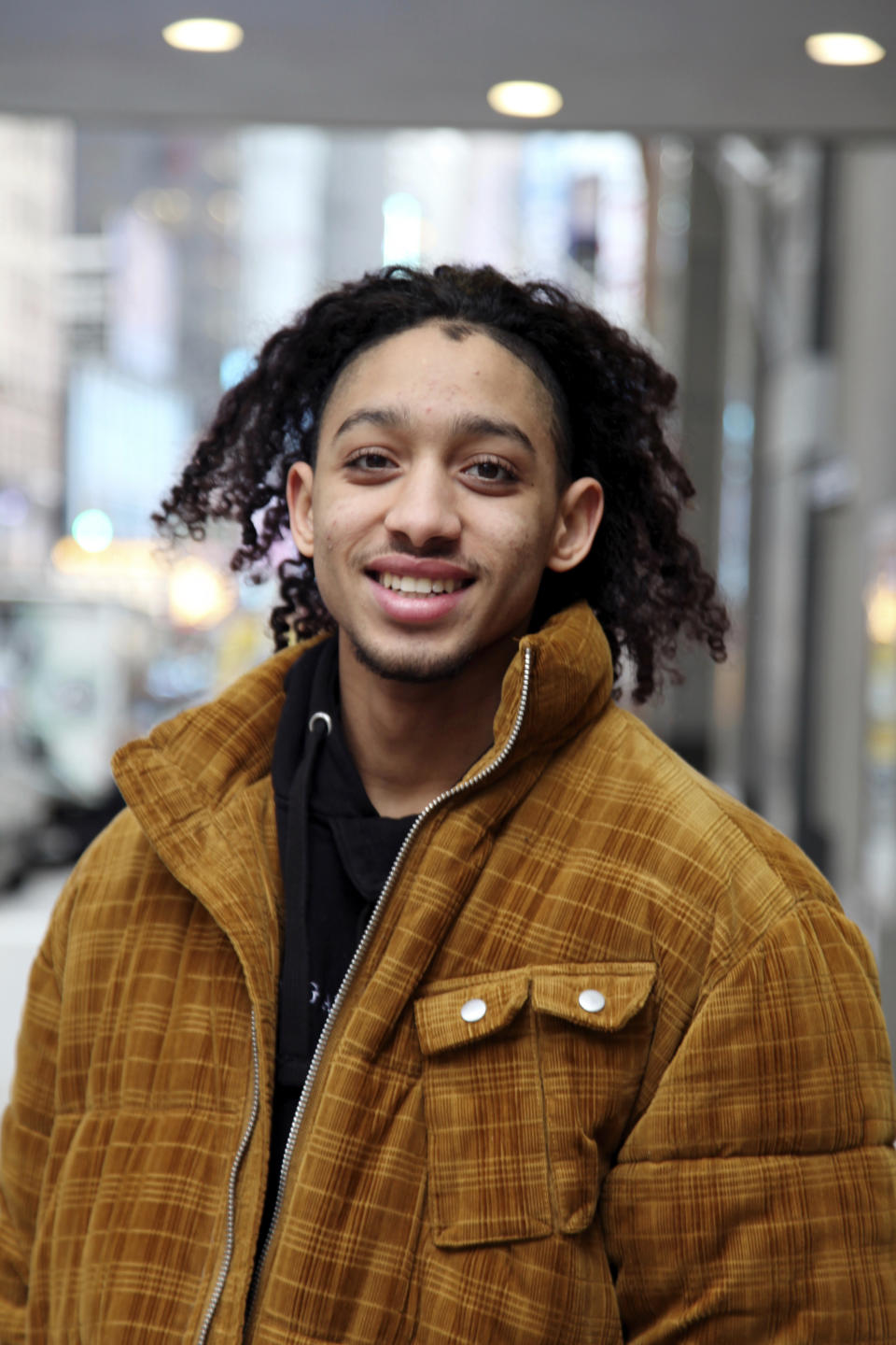 In this Tuesday, Feb. 18, 2020 photo, Israel Del Rosario poses outside the Broadway Theatre in New York, where he is making his Broadway debut in "West Side Story." The revival opens Thursday night and boasts 33 young people making their Broadway debuts. (Lisa Tolin via AP)