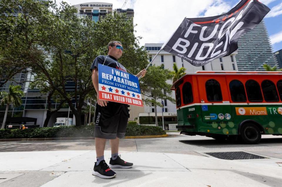 A pro-DeSantis demonstrator wears a message board outside the Miami Four Seasons hotel on Brickell Avenue on Wednesday, May 24, 2023, as supporters of Gov. Ron DeSantis gather for the start of this campaign for the Republican nomination for president. D.A. Varela dvarela@miamiherald.com