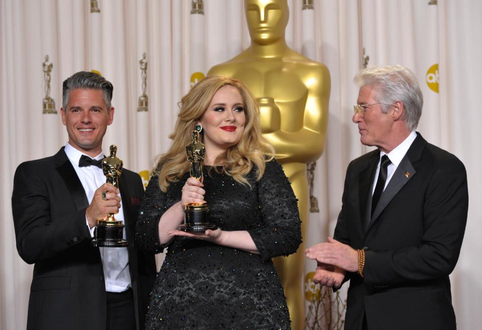 Adele and Paul Epworth pose with their award for best original song for "Skyfall" with presenter Richard Gere during the Oscars at the Dolby Theatre on Sunday Feb. 24, 2013, in Los Angeles. (Photo by John Shearer/Invision/AP)