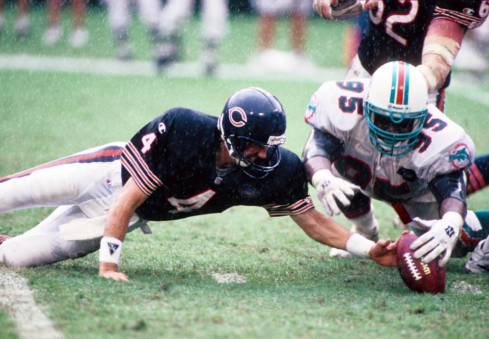 Nov 13, 1994; Miami, FL, USA; Chicago Bears quarterback Steve Walsh (4) and Miami Dolphins defensive tackle Tim Bowens (95) go after a loose ball at Dolphin Stadium. FILE PHOTO; Mandatory Credit: USA TODAY Sports