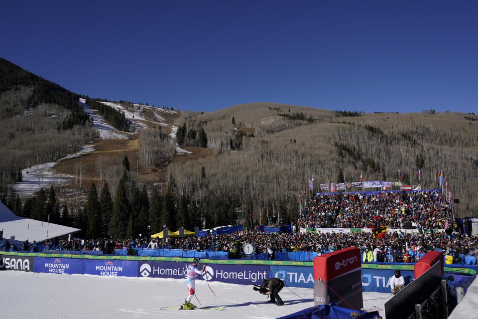 FILE - Skiing fans look on from bleachers before the start of World Cup downhill ski racing on Dec. 4, 2021, in Beaver Creek, Colo. Olympic athletes in Alpine skiing and other outdoor sports dependent on snow are worried as they see winters disappearing. (AP Photo/Gregory Bull, File)