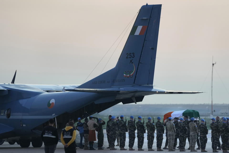 Irish U.N. peacekeepers carry to the inside of an Irish military plane the coffin of their comrade Pvt. Seán Rooney who was killed during a confrontation with residents near the southern town of Al-Aqbiya on Wednesday night, during his memorial procession at the Lebanese army airbase, at Beirut airport, Sunday, Dec. 18, 2022. (AP Photo/Hussein Malla)