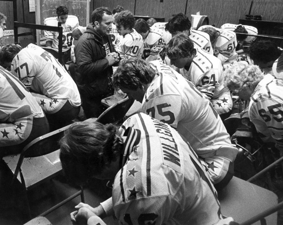 NOVEMBER 23, 1980: Gerry Faust, Nippert Stadium. Heads bowed, shoulder pads lowered, the Moeller High School Crusaders say one last Hail Mary with coach Gerry Faust before crushing Massillon, 30-7.