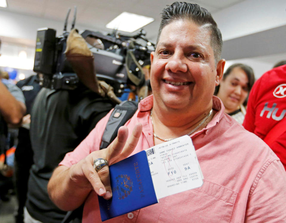 A passenger holds his Cuban passport Fort Lauderdale International Airport