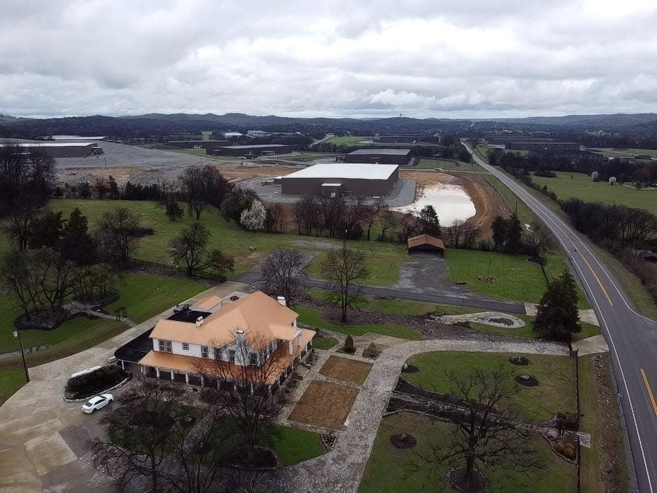 The Manor at ShaeJo in Lincoln County, Tennessee, shown in the foreground, co-owned by Christi Long, and the neighboring Jack Daniel Distillery barrel house operation.