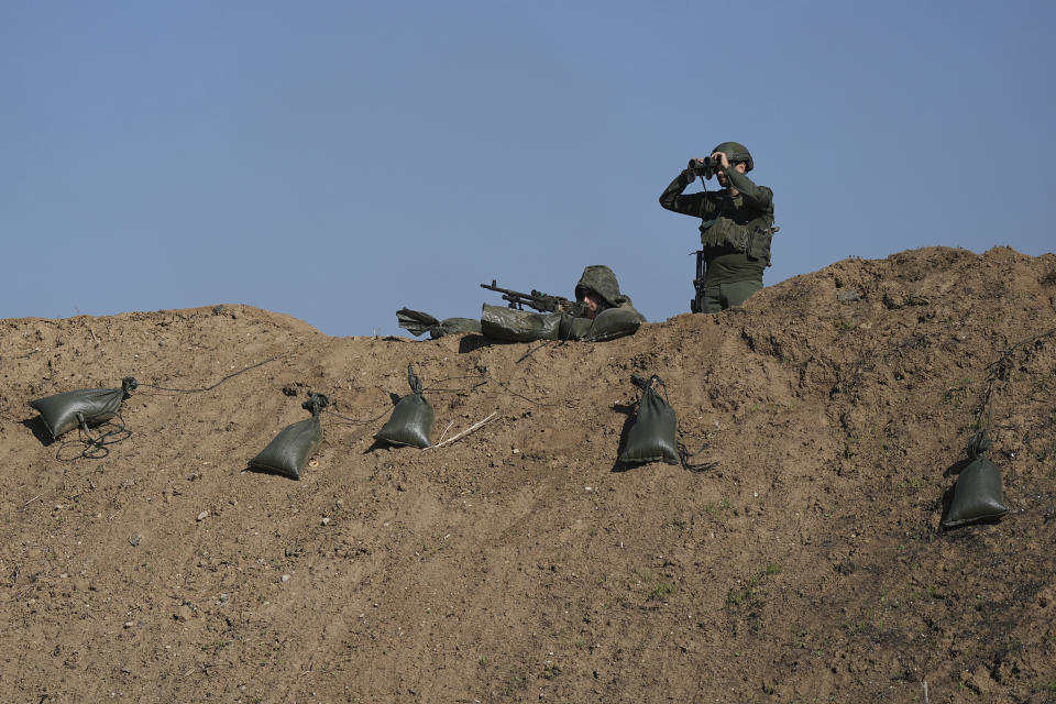 Israeli soldiers are seen near the border with the Gaza Strip, southern Israel, Thursday, Nov. 30, 2023. during a temporary cease-fire between Israel and Hamas. (AP Photo/Tsafrir Abayov)