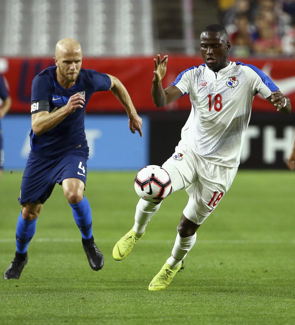 Panama forward Abdiel Arroyo (18) runs past United States midfielder Michael Bradley (4) with the ball during the first half of a men's international friendly soccer match, Sunday, Jan. 27, 2019, in Phoenix. (AP Photo/Ross D. Franklin)