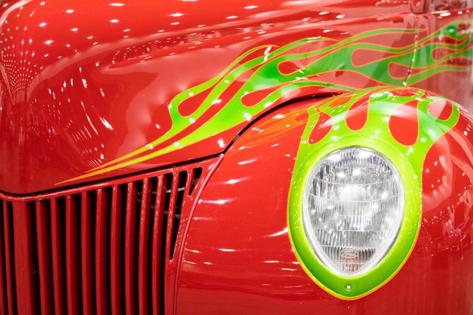 Neon green fire streaks across a red 1939 Ford 350 Chevy during the 2021 O’Reilly Auto Parts Cavalcade of Customs at the Duke Energy Convention Center. The auto show returns to the convention center from Friday-Sunday, Jan. 7-9, 2022.