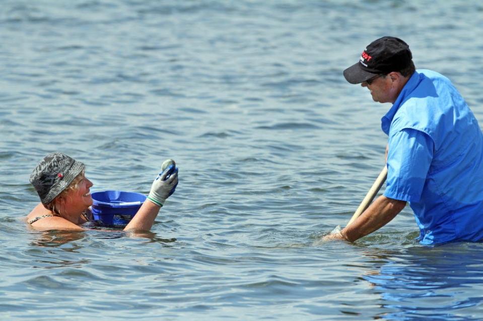 In August 2016, Lori and Hank Stoudt of West Warwick dig quahogs at Colt State Park.