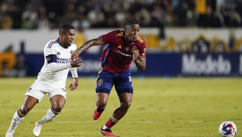 LA Galaxy forward Douglas Costa, left, and Real Salt Lake midfielder Nelson Palacio chase the ball during the first half of an MLS soccer match Saturday, Oct. 14, 2023, in Carson, Calif. (AP Photo/Ryan Sun)