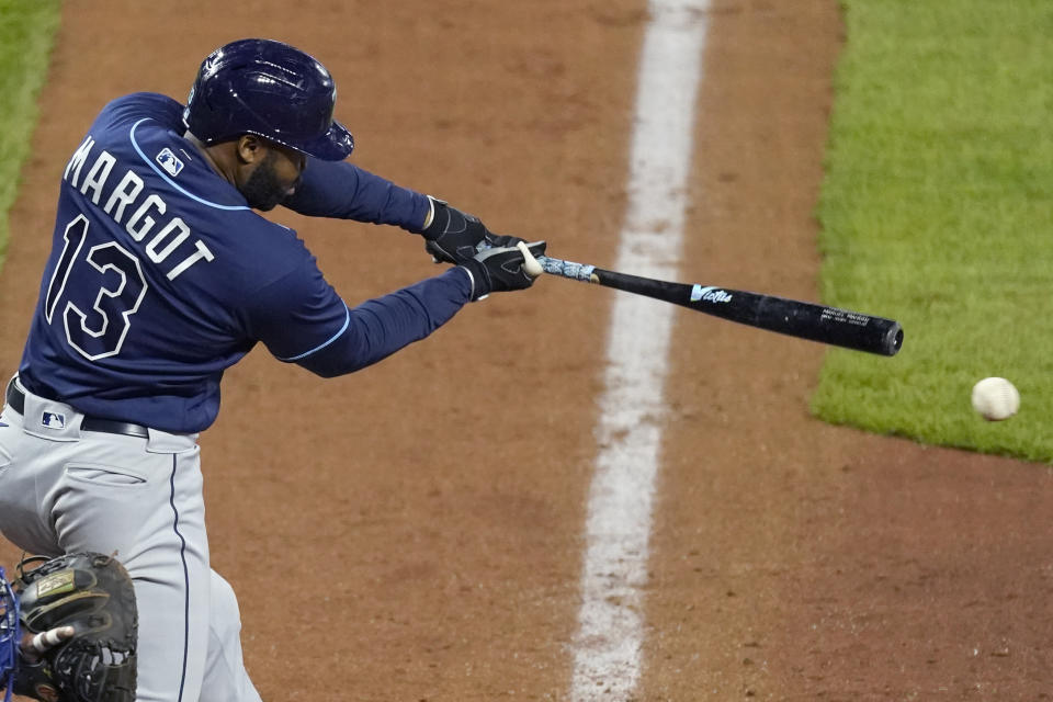 Tampa Bay Rays' Manuel Margot hits a two-run single during the sixth inning of a baseball game against the Kansas City Royals Tuesday, April 20, 2021, in Kansas City, Mo. (AP Photo/Charlie Riedel)