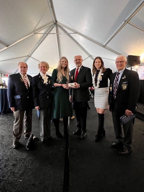 Tim Reid, the executive director of the Texas Panhandle War Memorial Center, hands over a piece of the original USS Arizona hull to Nikki Stratton, the granddaughter of Don Stratton, who was one of the last remaining survivors of the attack on the ship at Pearl Harbor. Stratton passed away Feb. 16, 2020, at the age of 97.