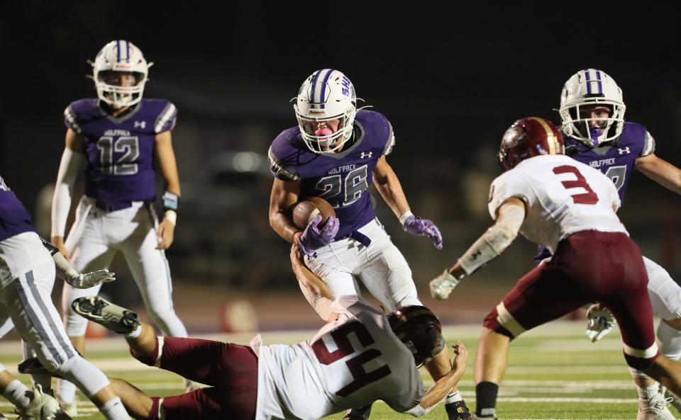 Shasta junior Ryder May, center, runs past West Valley's Wade Reginato, right, on Friday, Sept. 9, 2022, at Thompson Field in Redding.