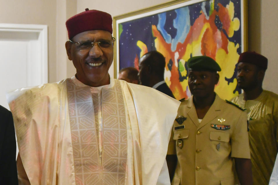 FILE- Nigerien President Mohamed Bazoum at the presidential palace in Niamey, Niger, March 16, 2023. Bazoum said Wednesday July 26 2023 that elements of the presidential guard tried to move against him and that the army will attack if they don't back down. Streets surrounding the presidential palace in the capital Niamey were blocked off as were some of the ministries. (Boureima Hama/Pool Photo via AP/File)