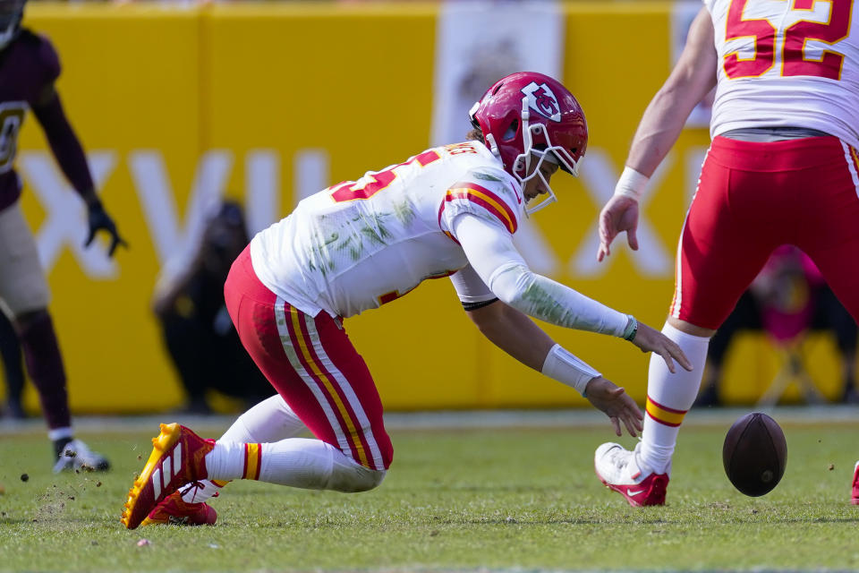 Kansas City Chiefs quarterback Patrick Mahomes (15) mishandles the football during the snap in the first half of an NFL football game against the Washington Football Team, Sunday, Oct. 17, 2021, in Landover, Md. (AP Photo/Alex Brandon)