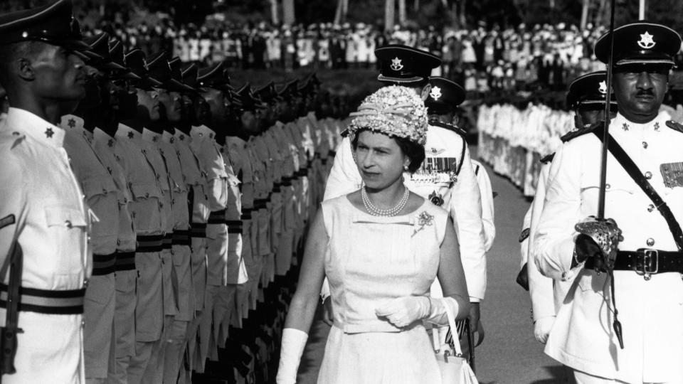 Queen Elizabeth II inspects a guard of honour in Trinidad during a royal tour of the Caribbean.