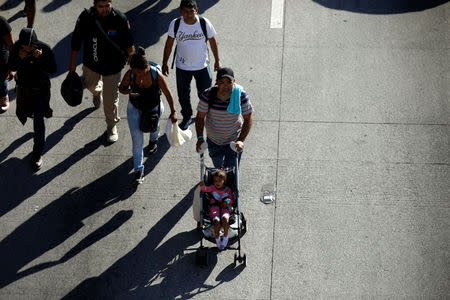 Salvadorans take part in a new caravan of migrants, set to head to the United States, as they leave San Salvador, El Salvador January 16, 2019. REUTERS/Jose Cabezas