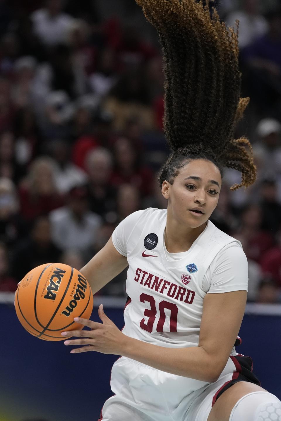 Stanford's Haley Jones grabs the ball during the first half of a college basketball game in the semifinal round of the Women's Final Four NCAA tournament Friday, April 1, 2022, in Minneapolis. (AP Photo/Charlie Neibergall)