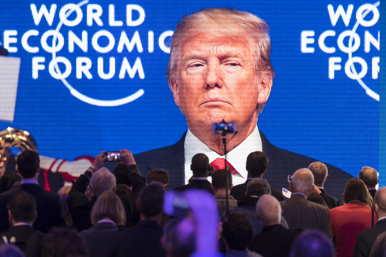 Participants watch the appearance of U.S. President Donald Trump on screen from an adjacent room, during the annual meeting of the World Economic Forum, WEF, in Davos, Switzerland, Friday, Jan. 26, 2018. (Gian Ehrenzeller/Keystone via AP)