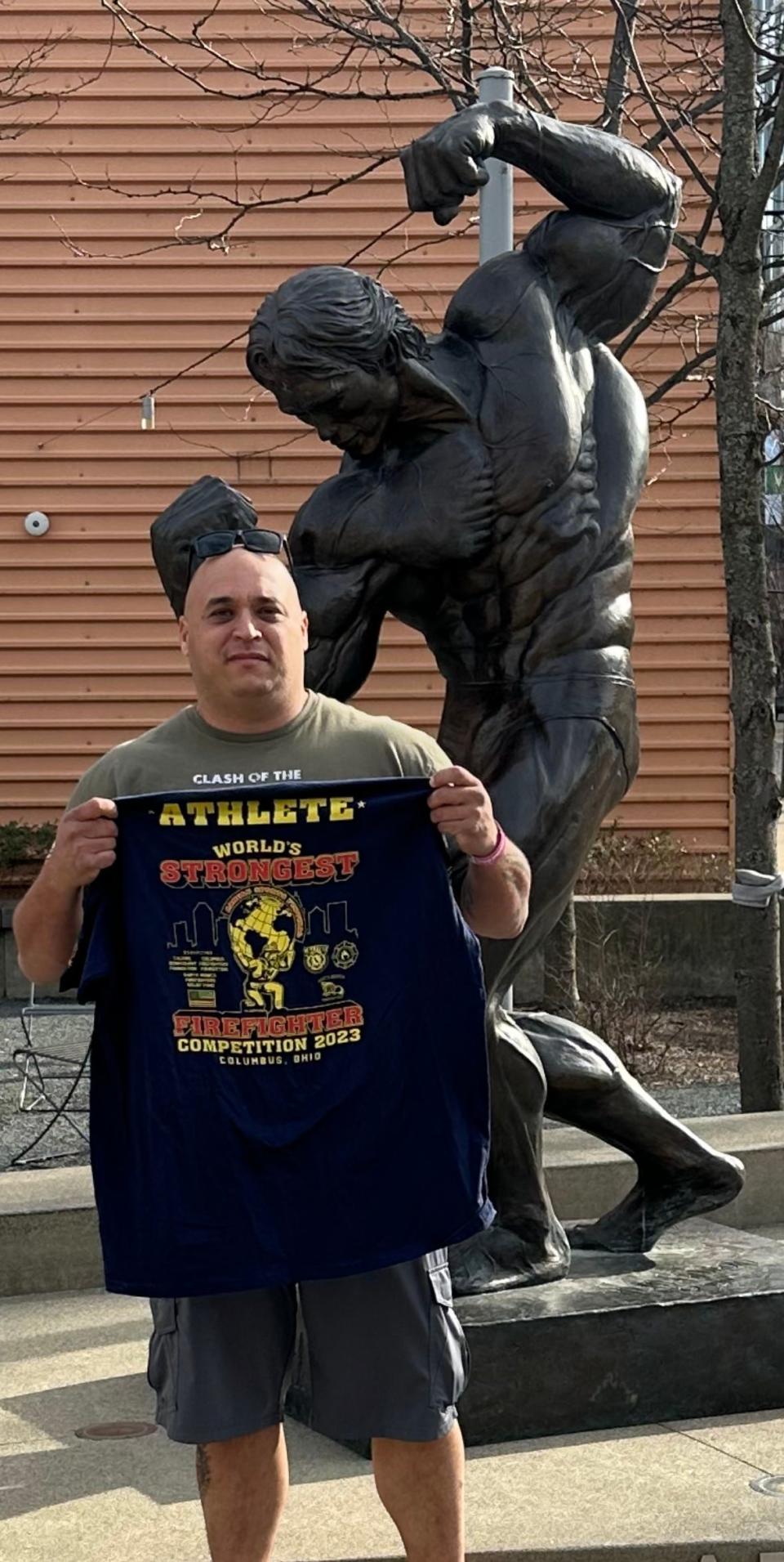 Salina firefighter Chris Rios stands in front of a statue of Arnold Schwarzenegger during the 2023 Arnold Sports Festival in Columbus, Ohio. Rios competed and placed 29th overall in the World's Strongest Firefighter Contest hosted at the festival this year.