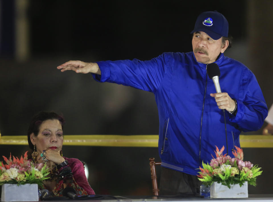 FILE - Nicaragua's President Daniel Ortega speaks during a ceremony in Managua, Nicaragua, March 21, 2019, accompanied by first lady and Vice President Rosario Murillo. Ortega and Murillo blame “terrorist” clergy for supporting the civil unrest they claim amounts to plotting a coup against them. Clergy and lay observers say the government is trying to quash the Catholic church because it remains the rare critic in Nicaragua that dares to oppose state violence and whose voice is respected by many citizens. (AP Photo/Alfredo Zuniga, File)