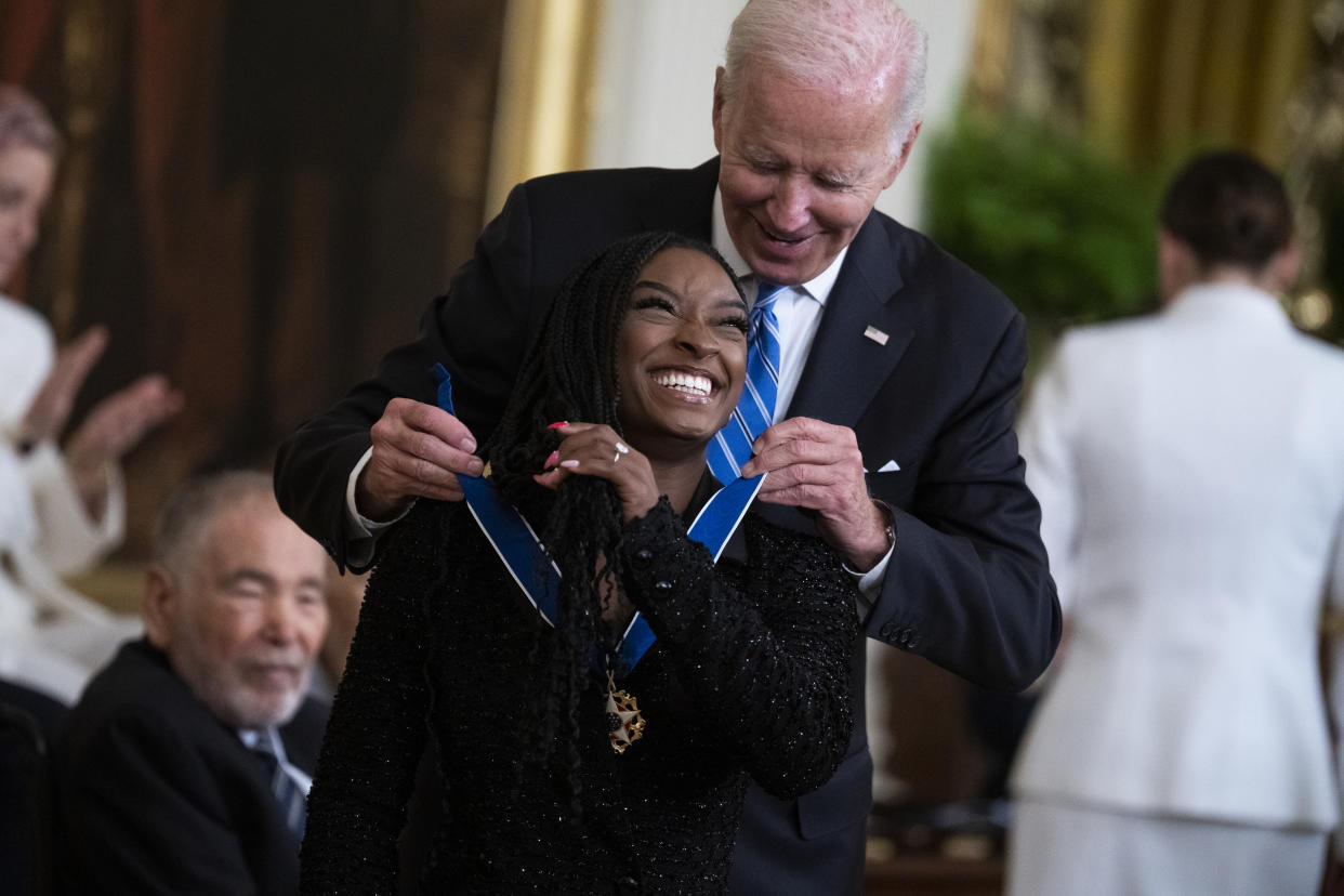 UNITED STATES - JULY 7: President Joe Biden presents the Presidential Medal of Freedom to gymnast Simone Biles, one of this years 17 recipients to receive the nation's highest civilian honor, during a ceremony at the White House on Thursday, July 7, 2022. (Tom Williams/CQ-Roll Call, Inc via Getty Images)